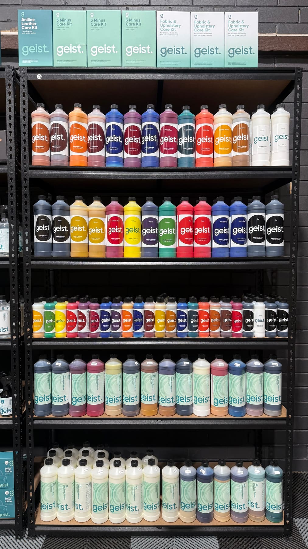 Full shelf of Geist leather and vinyl paints, dyes and care kits in the Perth Leather workshop